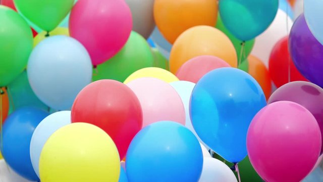 Many helium colorful balloons flying in the air. Celebration and birthday concept.