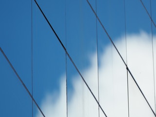 Fototapeta premium Sky shadows reflected on the glass of high building, Selective focus.