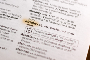 Ivanovsk, Russia - November 19, 2018: The word or phrase Alright in a dictionary.