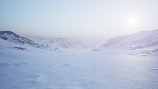 Aerial Landscape of snowy mountains and icy shores in Antarctica