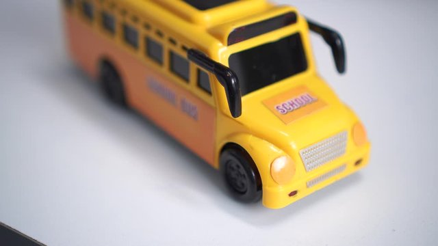 Kids Toy, student transport, Yellow School bus for children transports service on blur background. regularly used to transfer students to from school or school-related activities, Back to school idea