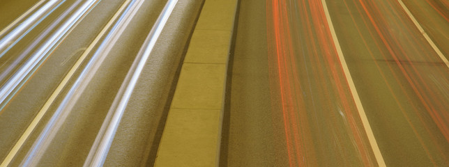 Long exposure photography of traffic on the city street. Road if filled out by cars. Rush hours. Right geometrical forms concepts. Soft pastel colors and background. High angle view / top view. 