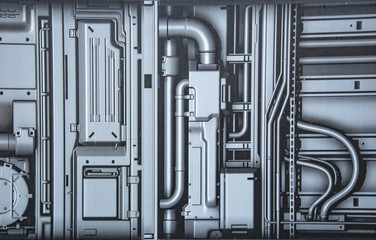 Pipes and wires on the wall.