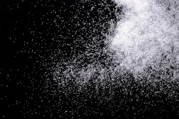 Abstract wallpaper design of white color shiny snow dust powder isolated on black background