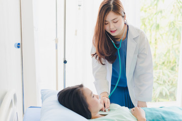 Fototapeta premium Asian woman doctor examined the patient's breathing stethoscopes. Lying in the patient's bed