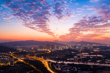 Fototapeta premium Aerial View of rural green fields in Hong Kong border and skylines in Shenzhen,China