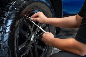 Hands Checking Tire Pressure.