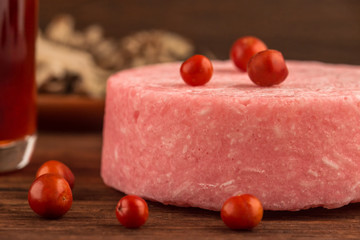 Natural cosmetics organic beauty concept. Dry shampoo herbal handmade homemade red soap with berries close up on dark wooden background.