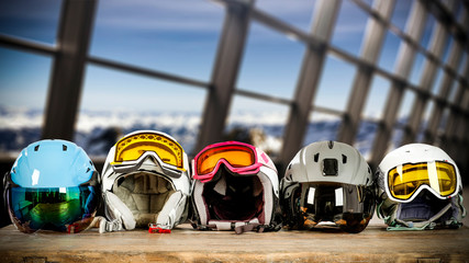 Winter background of ski equipment on board and big window with landscape of mountains. 