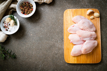 fresh raw middle chicken wings on wooden board
