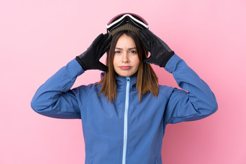 Obraz na płótnie Canvas Young skier woman over isolated pink background unhappy and frustrated with something. Negative facial expression