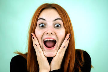 Happy pretty redhead girl looking laughing in camera in surprise