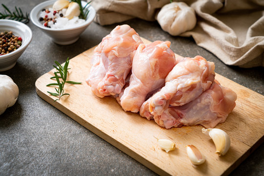 fresh raw chicken wings (drumette or drumstick) on wooden board