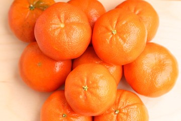 Orange mandarins lie on top of each other bright