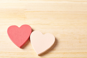 two hearts on wooden background