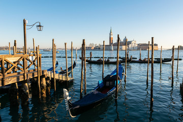 Obraz na płótnie Canvas Gondolas in Venice at golden hour