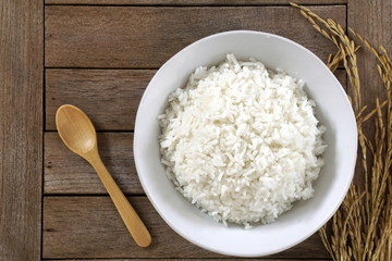 Thai jasmine rice and grains of rice on a wooden background