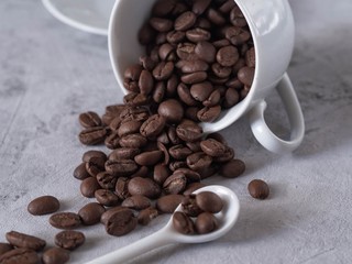 cup of coffee and beans on wooden background