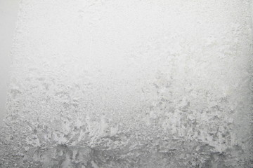 White window glass covered hoarfrost ice pattern texture. Cold nature winter background