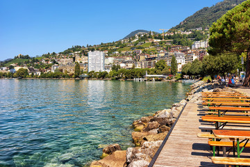 Montreux, Switzerland - August 27, 2016: Pier and people on the embankment of Geneva Lake in Montreux, Swiss Riviera © Roman Babakin