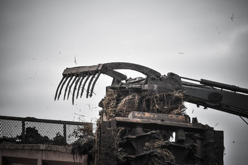 tractor and its telescopic fork taking the manure