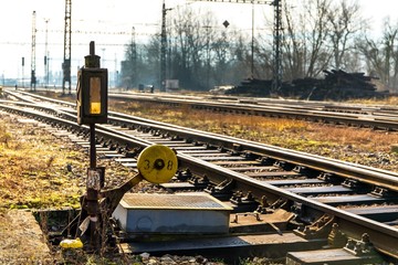 Old railway turnout and rail crossing. Sunlit railroad tracks and tracks running into the distance. Technical background of the sorting station. Czech Republic.