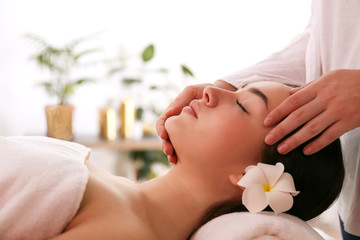 Obraz na płótnie Canvas Portrait young beautiful woman lying on the massage table in spa wellness salon. Beauty and health procedures for women concept. Close up, copy space, background.