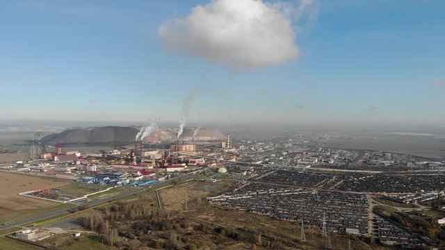 The smoke from the chimneys formed in the sky a large cloud above the potash industry, video taken from a drone, 4k