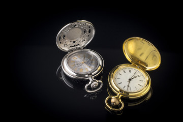 Vintage pocket watch on black background