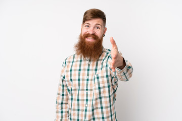 Redhead man with long beard over isolated white background shaking hands for closing a good deal