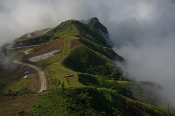Fototapeta premium Misty clouds cover mountains in Thailand.