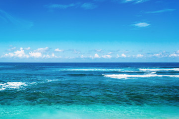 Fototapeta na wymiar Beach and beautiful tropical sea. Caribbean summer sea with blue water. White clouds on a blue sky over summer sea. Tropical sea relax.