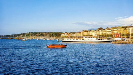 Boats and steamboat at Geneva Lake at Promenade du Lac in summer, Geneva, Switzerland. People on...