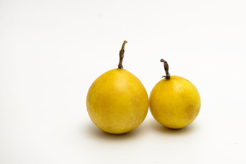 Two Golden passion fruit isolated on white background.