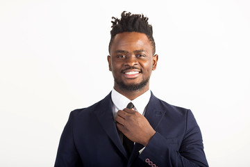 handsome young african man in a suit on a white background