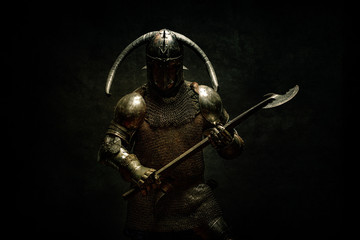 Portrait of a Viking Berserker warrior, holding a halberd in his hands
