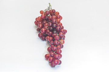 A bunch of red grapes isolated on a white background.
