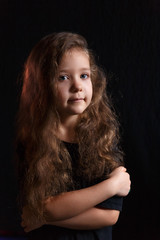 girl with long curly hair on a black background