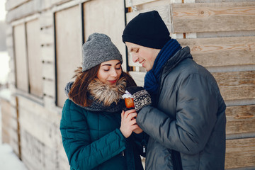 Young and loving couple standing in a winter park