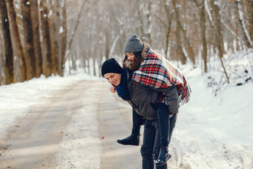 Young and loving couple walking in a winter park
