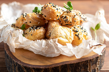 Beetroot carpaccio with walnuts, goat cheese, lettuce and spinach. Dressed with sauce. On a dark background.