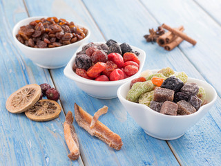 dried fruits in a white plate on a blue background.