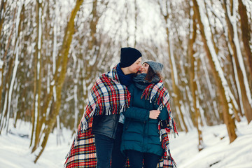 Fototapeta na wymiar Young and loving couple walking in a winter park