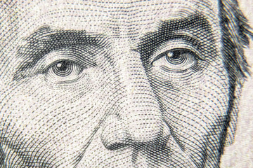 Abraham Abe Lincoln face on 5 dollar bill close up. Detail of new currency note. Macro view of...