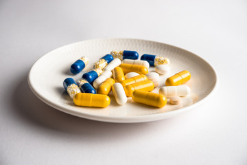 Different tablets, pills, medications drugs on white background
