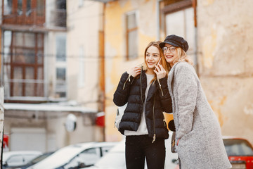 Fototapeta premium Fashion girl in a winter city. Girl in a glasses. Lady use the phone