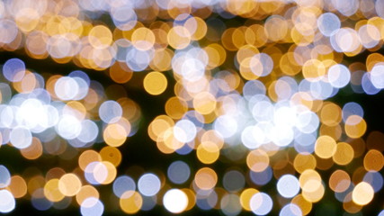 Christmas light darkbackground golden blur bokeh abstract spot city blurry and defocus. Blury focus gold and light bright shiny on black color backdrop.