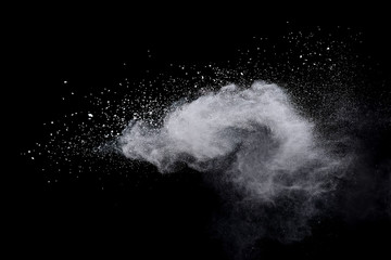 Freeze motion of white color powder exploding on dark background. 