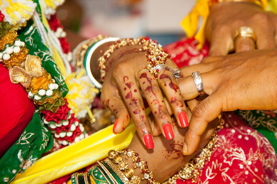 Hands of newlyweds with wedding rings bright national decorations beautiful paintings on their hands. Wedding, traditions. world tourism.
