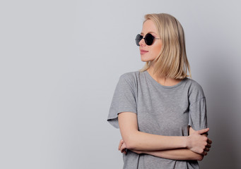 Fototapeta premium serious blonde woman in sunglasses on white background